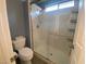 Bathroom featuring a stand-up shower with white tiling and glass door at 5824 Red Gull St, Las Vegas, NV 89149