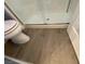 Modern bathroom with wood-look tile floors and a glass-enclosed shower at 5824 Red Gull St, Las Vegas, NV 89149