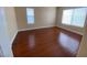 Sunlit bedroom featuring hardwood flooring and windows bringing in natural light at 5824 Red Gull St, Las Vegas, NV 89149