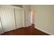 Cozy bedroom features wood floors, closet, an open doorway to another room, and natural light from windows at 5824 Red Gull St, Las Vegas, NV 89149