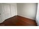 Cozy bedroom with hardwood floors and a closet, illuminated by natural light from the windows at 5824 Red Gull St, Las Vegas, NV 89149