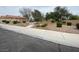Stone-covered front yard featuring a paved walkway and manicured bushes at 5824 Red Gull St, Las Vegas, NV 89149