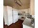 This bright kitchen showcases white appliances, modern light fixtures and countertops, enhancing its aesthetic at 5824 Red Gull St, Las Vegas, NV 89149