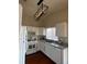 Bright kitchen features white cabinets, granite countertops, and modern light fixtures with natural light from a window at 5824 Red Gull St, Las Vegas, NV 89149