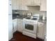 The kitchen features white appliances, granite counters, and ample cabinet space at 5824 Red Gull St, Las Vegas, NV 89149
