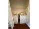Convenient laundry area with a washer and dryer, plus shelving for storage, inside of the home at 5824 Red Gull St, Las Vegas, NV 89149