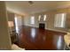 Spacious living room featuring wood flooring, a fireplace, and plenty of natural light at 5824 Red Gull St, Las Vegas, NV 89149