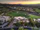 Breathtaking aerial view of a luxury home nestled on a golf course with stunning mountain and city views at sunset at 583 Saint Croix St, Henderson, NV 89012