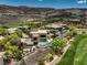 An aerial view showcasing the property and its stunning pool, golf course views, and hillside neighborhood at 583 Saint Croix St, Henderson, NV 89012