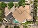 An aerial view of a uniquely shaped home featuring a sleek modern roof and gorgeous pool and outdoor kitchen at 583 Saint Croix St, Henderson, NV 89012