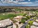 A breathtaking aerial view of the property, with lush green golf course, city views, and surrounding neighborhood at 583 Saint Croix St, Henderson, NV 89012