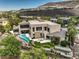 An aerial view showcases the property, its outdoor living spaces, lush landscaping and sweeping golf course views at 583 Saint Croix St, Henderson, NV 89012