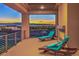 Relax on the spacious balcony with city views, chaise lounges, and a cozy fireplace at 583 Saint Croix St, Henderson, NV 89012