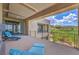 Spacious covered balcony with sleek lounge furniture and panoramic views of the golf course and mountains at 583 Saint Croix St, Henderson, NV 89012