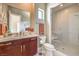 Elegant bathroom with dark wood cabinetry, marble countertop, and a glass-enclosed shower with white tile at 583 Saint Croix St, Henderson, NV 89012