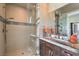 Modern bathroom featuring a marble countertop, a glass-enclosed shower, and neutral tile with decorative accents at 583 Saint Croix St, Henderson, NV 89012