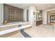 Bathroom featuring soaking tub on a raised platform with stylish tile accents at 583 Saint Croix St, Henderson, NV 89012