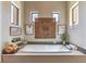Soaking tub featuring tile surround, artwork and a decorative wood carving at 583 Saint Croix St, Henderson, NV 89012