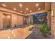 Spacious covered entryway features stone pillars, recessed lighting, and serene landscaping at 583 Saint Croix St, Henderson, NV 89012
