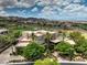 This exterior shot highlights the home's desert landscaping, complemented by lush trees and palm trees, plus a circular driveway at 583 Saint Croix St, Henderson, NV 89012