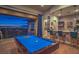 Entertaining game room with a pool table, bar area, and a view of the city skyline at 583 Saint Croix St, Henderson, NV 89012