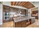 Close up of kitchen showing a large island with granite countertop and custom wood cabinetry at 583 Saint Croix St, Henderson, NV 89012