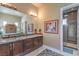 Luxurious main bathroom with dual sinks, dark wood cabinetry, and tile shower at 583 Saint Croix St, Henderson, NV 89012