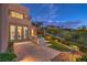 Outdoor kitchen with stainless steel appliances, lush landscaping, and a serene backyard at 583 Saint Croix St, Henderson, NV 89012