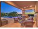Inviting outdoor living space with comfortable seating, fireplace, and a stunning infinity pool overlooking a scenic view at 583 Saint Croix St, Henderson, NV 89012