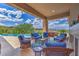 Inviting patio with wicker seating, a hot tub, a built-in fireplace, and stunning views of the landscape at 583 Saint Croix St, Henderson, NV 89012