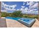 Beautiful pool and spa overlooking a lush green golf course with clear blue skies and scattered clouds at 583 Saint Croix St, Henderson, NV 89012