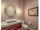 Stylish powder room with vessel sink, decorative mirror, and shell artwork at 583 Saint Croix St, Henderson, NV 89012