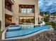 Contemporary home with a sleek pool, a jacuzzi, an outdoor kitchen, and ample patio space perfect for entertaining guests at 583 Saint Croix St, Henderson, NV 89012