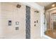 Luxurious shower with tile surround, multiple shower heads and glass door at 583 Saint Croix St, Henderson, NV 89012