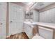 Well-lit bathroom featuring a vanity with a sink, toilet, and mirrored cabinets at 601 Cabrillo Cir # 536, Henderson, NV 89015