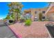 Apartment building with manicured landscaping, covered parking, and red rock ground cover at 601 Cabrillo Cir # 536, Henderson, NV 89015
