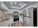 Bright kitchen with stainless steel appliances, white cabinetry, and recessed lighting at 601 Cabrillo Cir # 536, Henderson, NV 89015