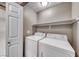 Convenient laundry room with a white washer, dryer, and built-in shelving at 601 Cabrillo Cir # 536, Henderson, NV 89015