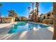 Refreshing community pool surrounded by lush landscaping and palm trees on a sunny day at 601 Cabrillo Cir # 536, Henderson, NV 89015