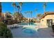 Community pool area with a hot tub, lounge chairs, palm trees, and beautiful landscaping at 601 Cabrillo Cir # 536, Henderson, NV 89015