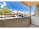 View from balcony showing the parking area and community buildings under a bright blue sky at 7300 Pirates Cove Rd # 1032, Las Vegas, NV 89145