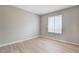 Neutral bedroom with wood-look floors and window at 7300 Pirates Cove Rd # 1032, Las Vegas, NV 89145
