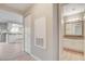 Bright entryway with wood-look floors, utility access, and bathroom access at 7300 Pirates Cove Rd # 1032, Las Vegas, NV 89145