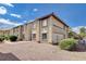 Tan two-story condo units featuring well-kept shrubbery and a gravel lawn area at 7300 Pirates Cove Rd # 1032, Las Vegas, NV 89145