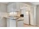 Kitchen featuring a breakfast bar, white cabinets, granite counters, and stainless steel appliances at 7300 Pirates Cove Rd # 1032, Las Vegas, NV 89145