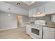 Kitchen offers ample counter space, white cabinetry and views of the living room at 7300 Pirates Cove Rd # 1032, Las Vegas, NV 89145