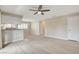 Open-concept living room boasts a ceiling fan and wood-look flooring, providing a bright and airy feel at 7300 Pirates Cove Rd # 1032, Las Vegas, NV 89145