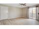 Living room featuring modern wood-look flooring and sliding glass door to outside at 7300 Pirates Cove Rd # 1032, Las Vegas, NV 89145