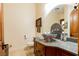 Stylish powder room featuring unique sink design, granite countertop, and modern fixtures at 8120 W Red Coach Ave, Las Vegas, NV 89129