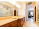 Spacious bathroom with dual vanities, stone countertops, and a glass block shower at 8120 W Red Coach Ave, Las Vegas, NV 89129